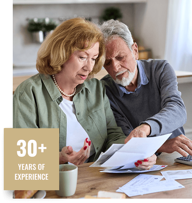 senior couple reviewing documents kitchen table