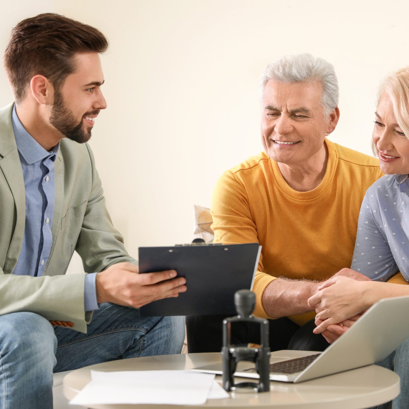 Male,Notary,Working,With,Mature,Couple,In,Office
